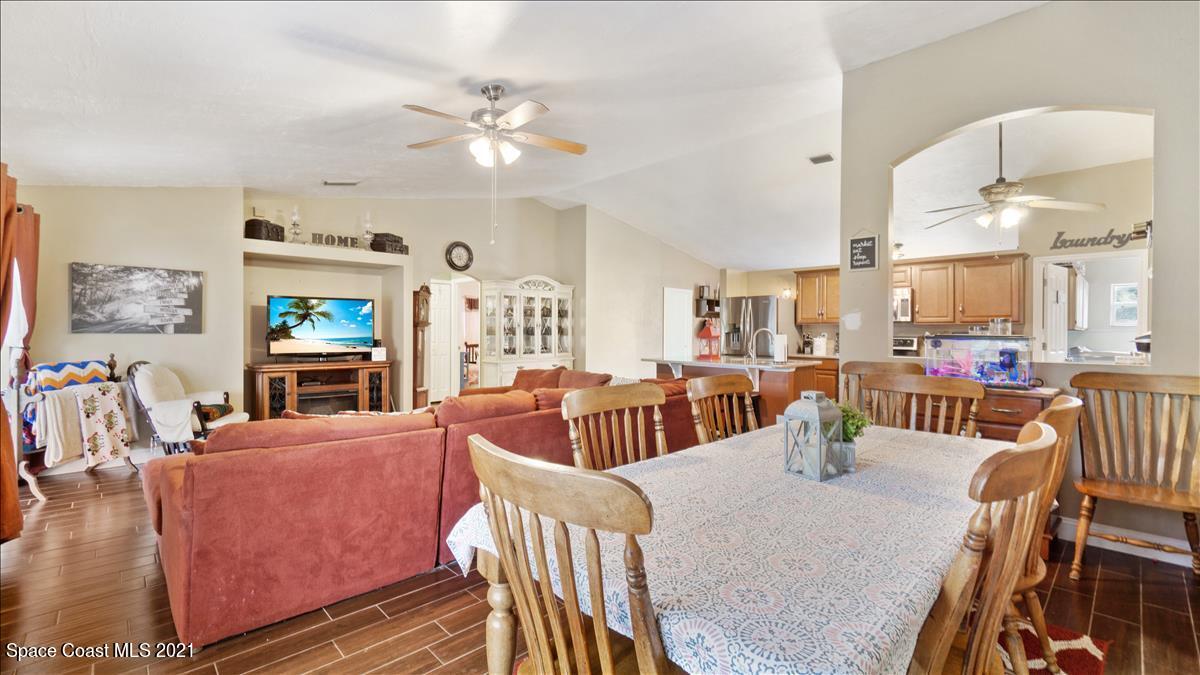 7220 Freeport Road Cocoa, FL 32927 - Photo 16 of 25 a living room with fireplace furniture and a large window