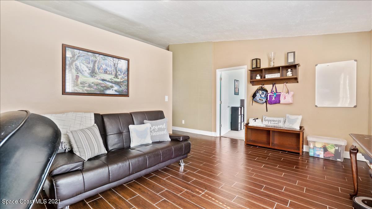 7220 Freeport Road Cocoa, FL 32927 - Photo 18 of 25 a living room with furniture and a wooden floor