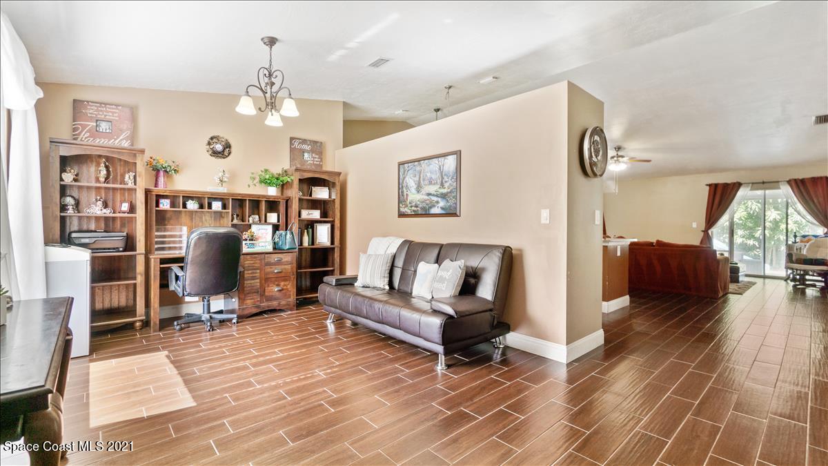 7220 Freeport Road Cocoa, FL 32927 - Photo 20 of 25 a living room with fireplace furniture and a rug