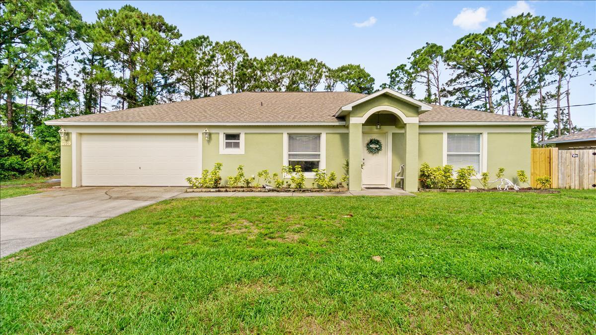 7220 Freeport Road Cocoa, FL 32927 - Photo 3 of 25 a front view of house with yard and green space
