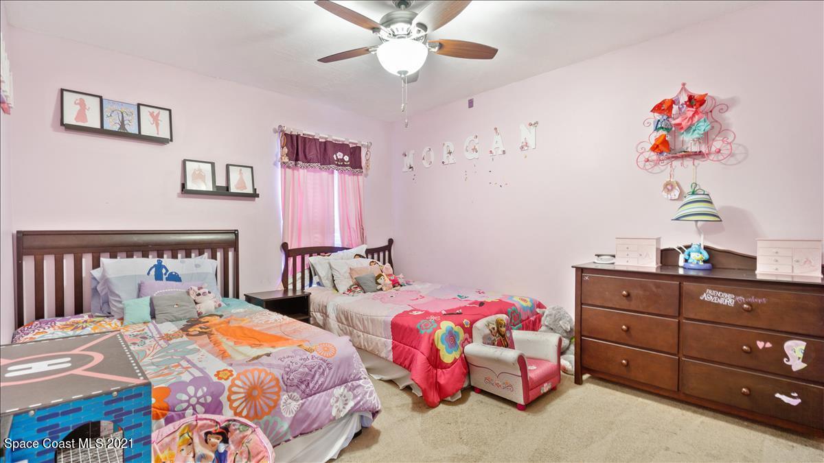 7220 Freeport Road Cocoa, FL 32927 - Photo 23 of 25 a bedroom with two beds and a dresser