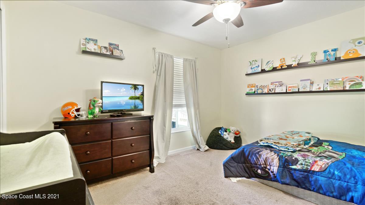 7220 Freeport Road Cocoa, FL 32927 - Photo 24 of 25 a bed room with a bed and a mirror