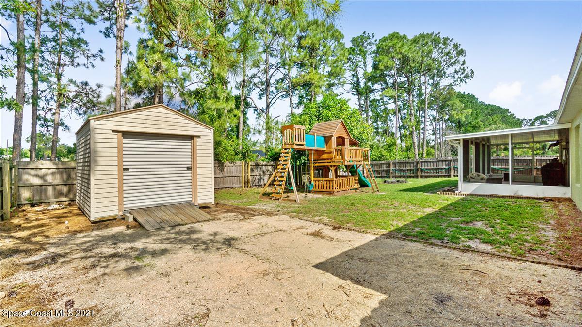 7220 Freeport Road Cocoa, FL 32927 - Photo 5 of 25 a front view of a house with garden