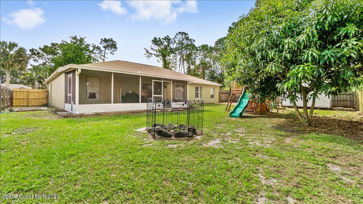 7220 Freeport Road Cocoa, FL 32927 - Photo 6 of 25 a front view of a house with garden