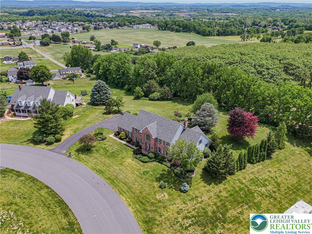 4542 Springfield Drive Coplay, PA 18037 - Photo 5 of 89 Discover a private setting, where this home rests among mature trees and verdant landscapes.