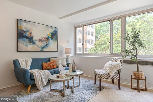 a outdoor living room with furniture and a large window
