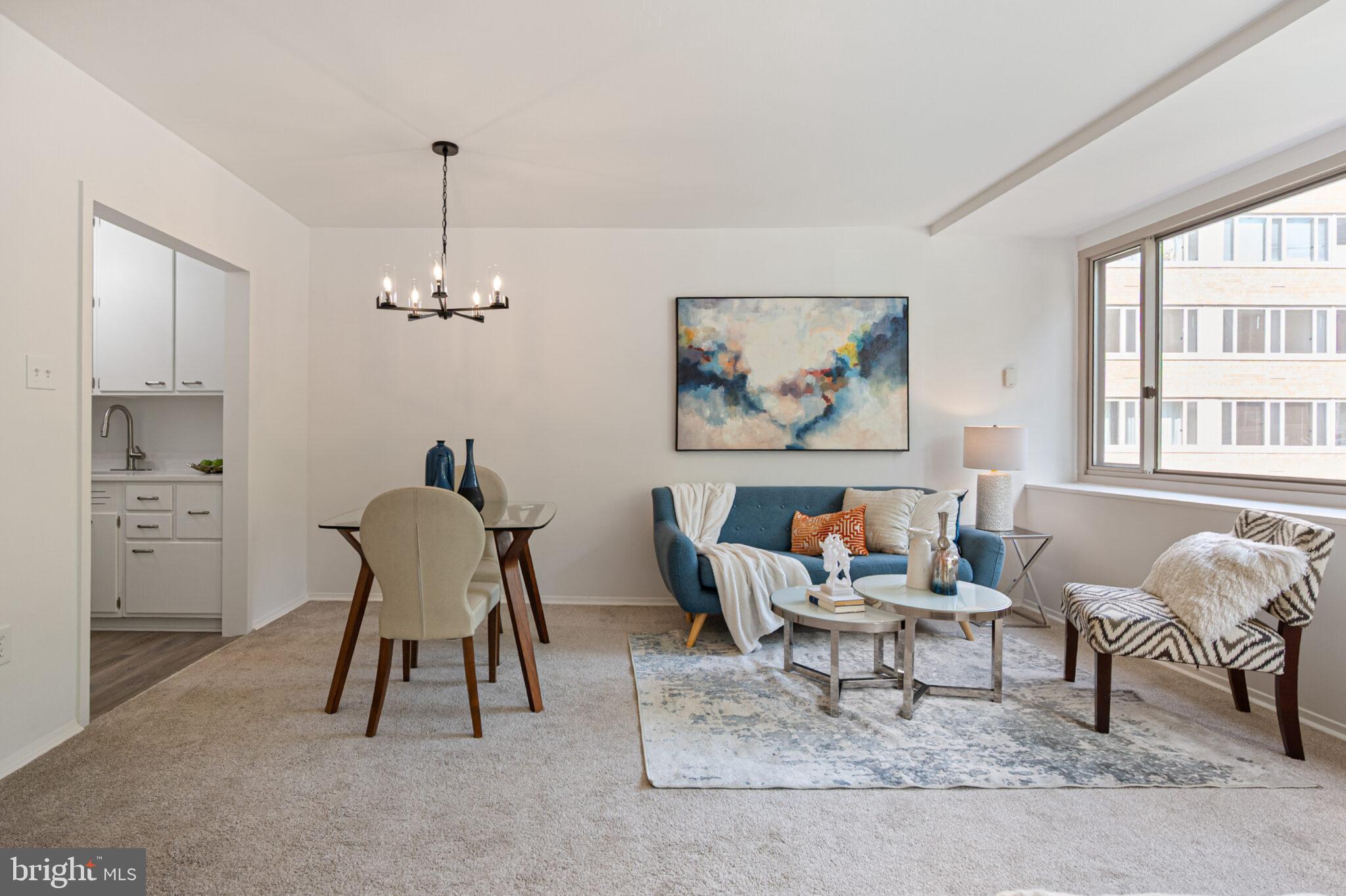 4101 Cathedral Avenue Northwest, Unit 616 Washington, DC 20016 - Photo 4 of 27 a living room with furniture a rug and a window