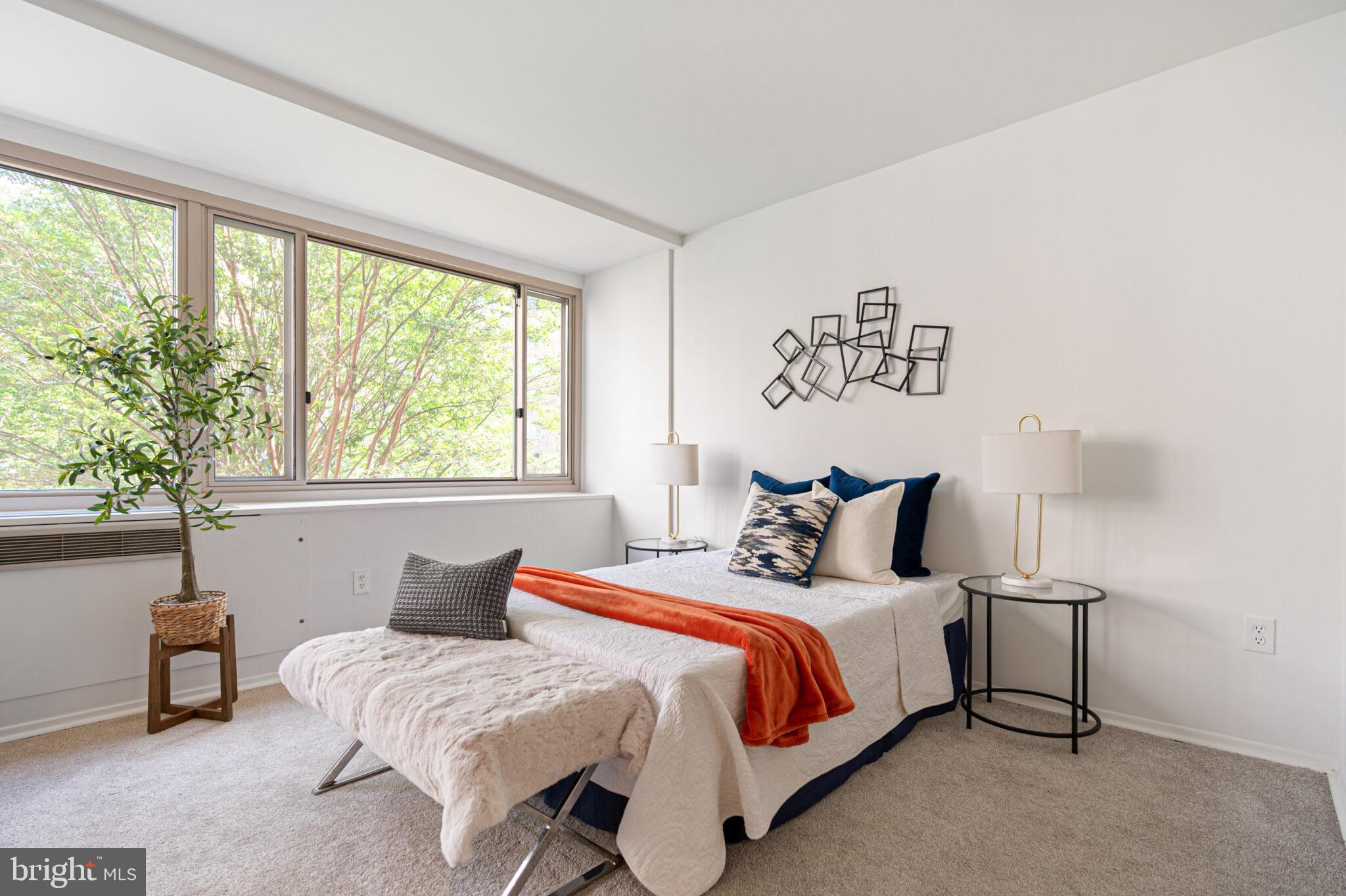 4101 Cathedral Avenue Northwest, Unit 616 Washington, DC 20016 - Photo 7 of 27 a bedroom with a bed and a large window