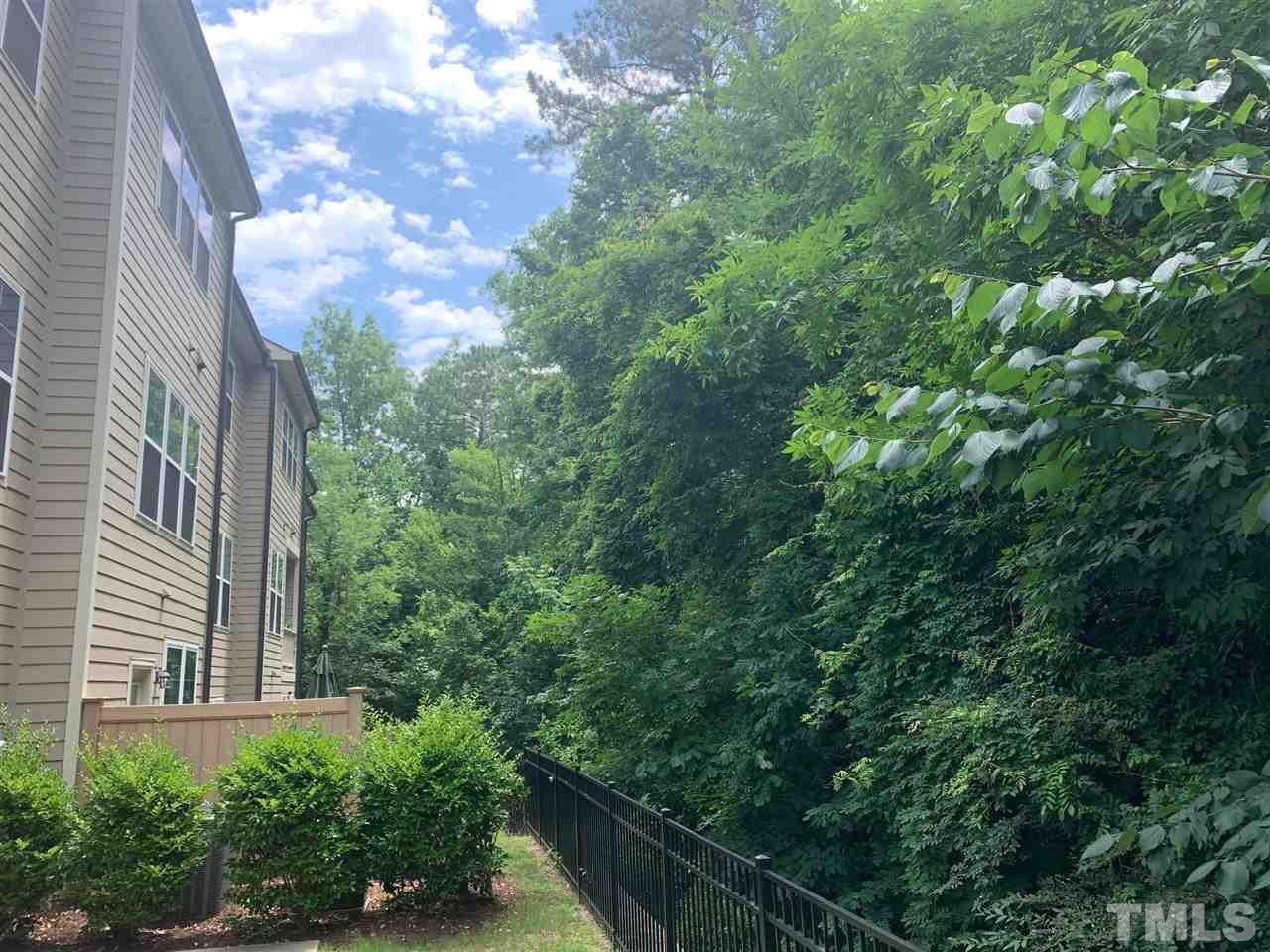 225 Penley Circle Raleigh, NC 27609 - Photo 2 of 18 a view of a yard with plants and wooden fence