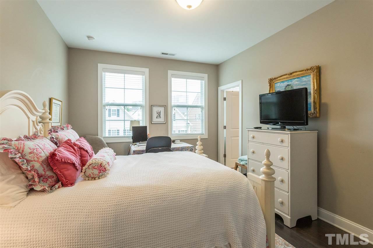 225 Penley Circle Raleigh, NC 27609 - Photo 12 of 18 a bedroom with a bed and a flat tv screen on dresser