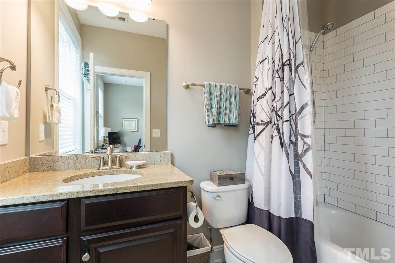 225 Penley Circle Raleigh, NC 27609 - Photo 13 of 18 a bathroom with a sink a toilet and shower curtain