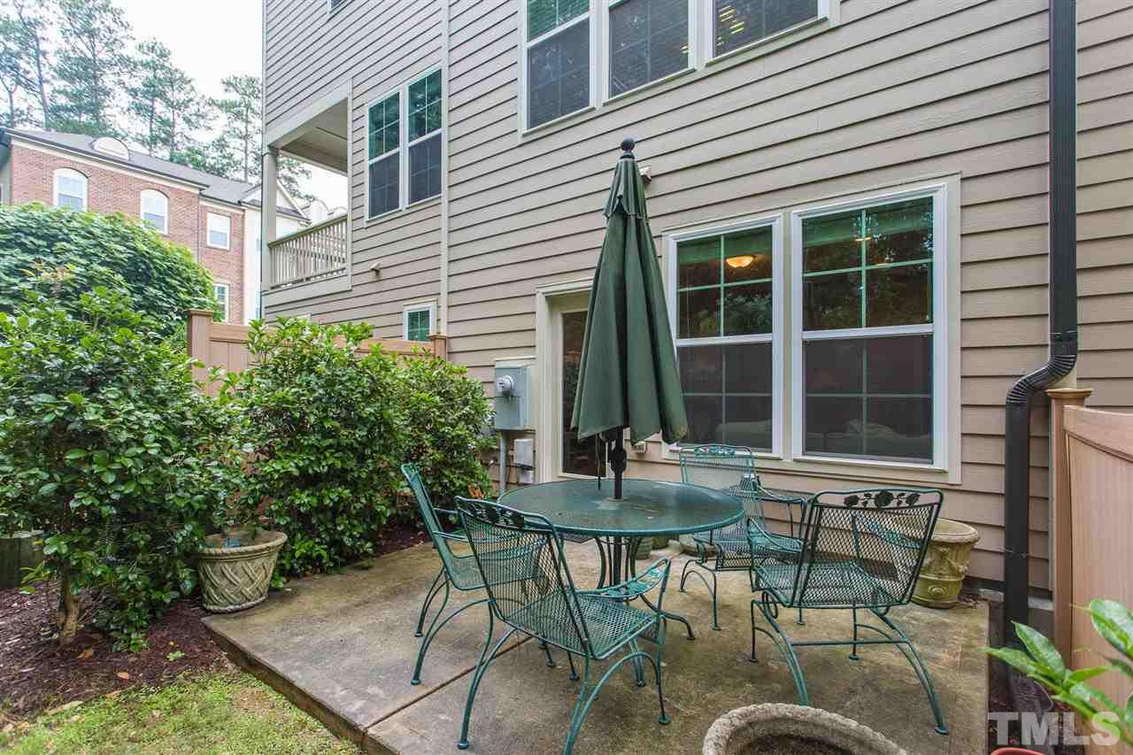 225 Penley Circle Raleigh, NC 27609 - Photo 18 of 18 a view of a patio with table and chairs and potted plants