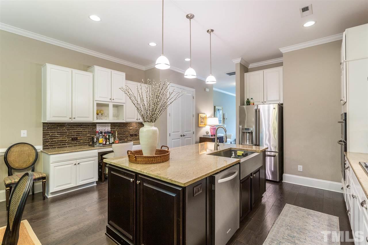 225 Penley Circle Raleigh, NC 27609 - Photo 7 of 18 a kitchen with stainless steel appliances granite countertop a sink a stove and a refrigerator