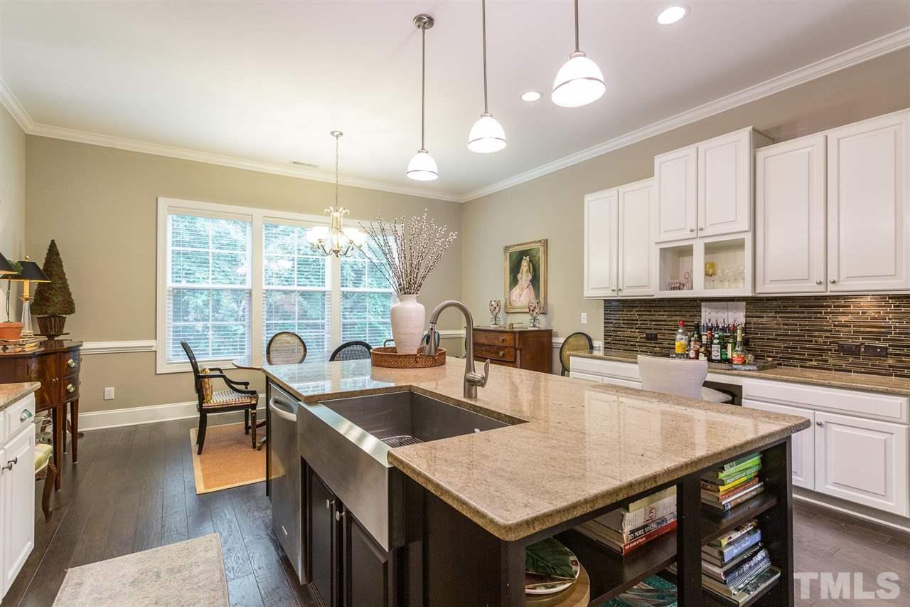 225 Penley Circle Raleigh, NC 27609 - Photo 8 of 18 a kitchen with a table chairs sink and cabinets