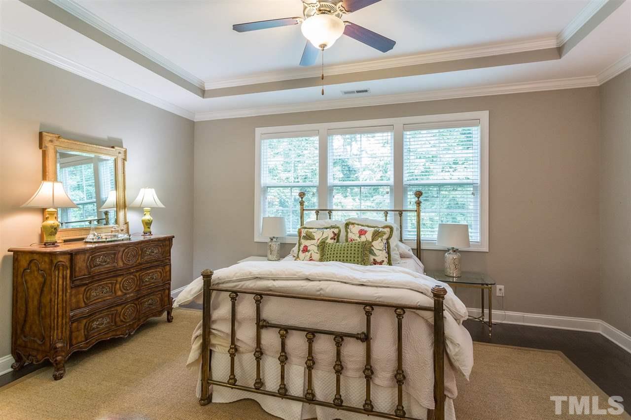 225 Penley Circle Raleigh, NC 27609 - Photo 10 of 18 a bedroom with a bed and a large window