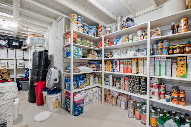 1426 South 1450th Street West Mapleton, UT 84664 - Photo 36 of 50 Extensive storage area featuring white built-in shelving, exposed ceiling beams, and concrete flooring