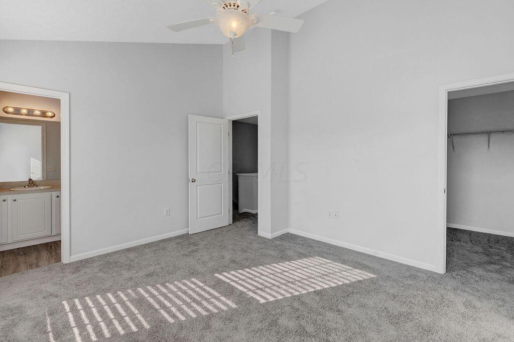 6345 Needletail Road, Unit 24634 Columbus, OH 43230 - Photo 17 of 58 • New gray carpet ~ 2021 • Gray painted walls • Vaulted ceiling • Lighted ceiling fan • 2” blinds