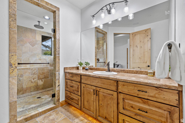 98 Bridge Road Rockville, UT 84763 - Photo 18 of 75 Primary Suite – En-Suite Full Bathroom. Full bathroom with vanity, a shower stall, stone tile floors, and recessed lighting