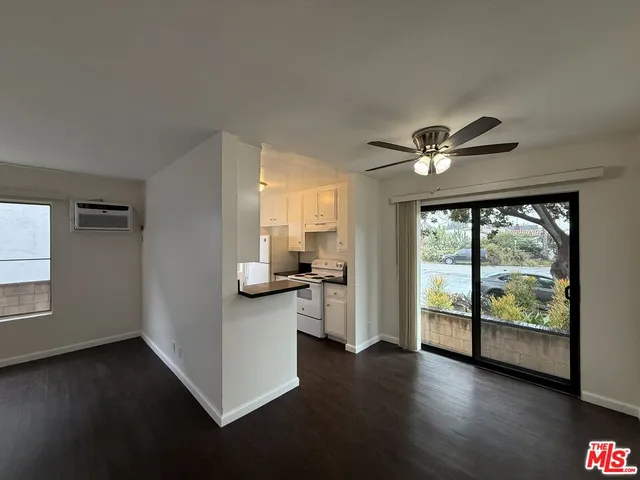 a view of a living room with hardwood floor and a large window