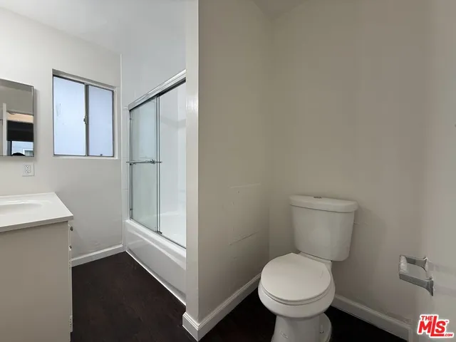 a white toilet sitting next to a bathroom sink
