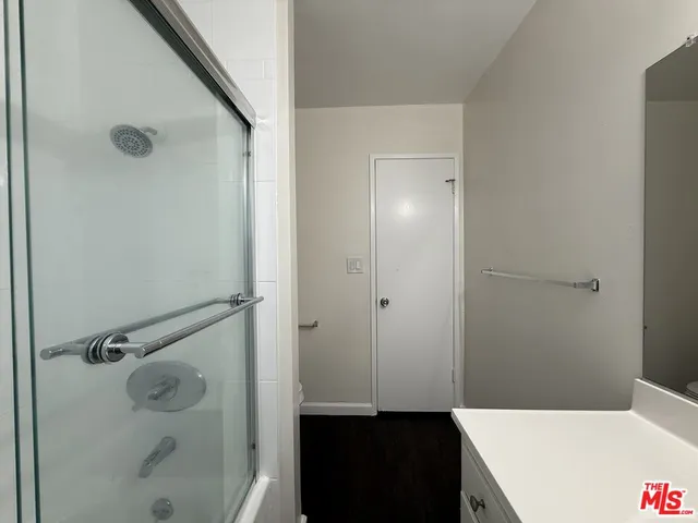 a bathroom with a shower and a sink