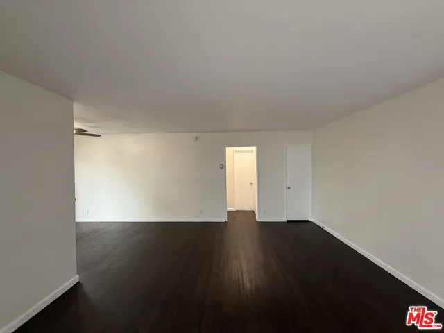 a view of an empty room and wooden floor