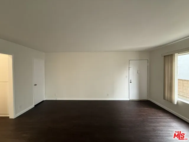a view of an empty room and wooden floor