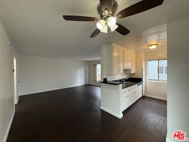 a kitchen with stainless steel appliances a stove a sink and a microwave
