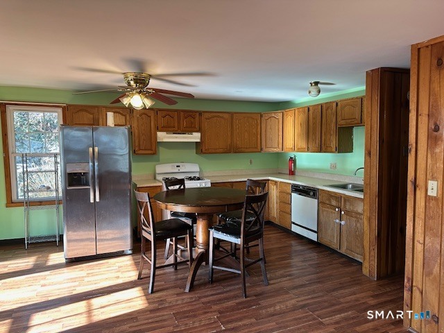 126 Smith Street, Unit 3 Derby, CT 06418 - Photo 8 of 10 a kitchen with granite countertop a refrigerator a stove a sink and island with wooden floor