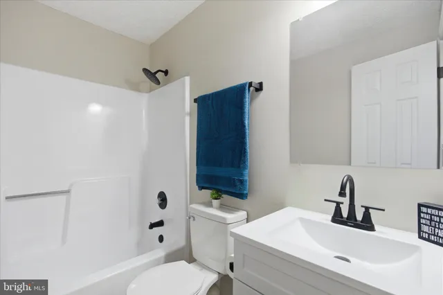 an empty room with windows and fireplace