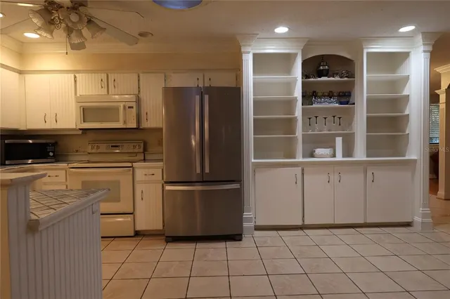 a kitchen with stainless steel appliances a refrigerator and cabinets
