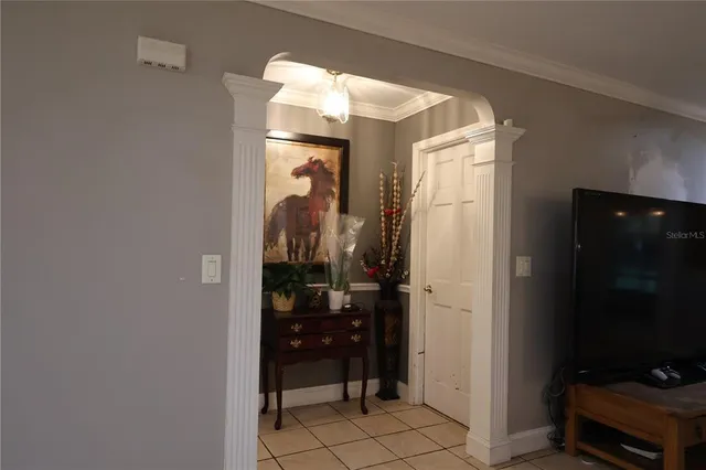 a bedroom with a bed and a flat tv screen on dresser