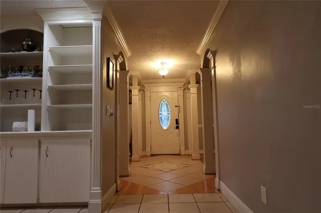 a kitchen with granite countertop a refrigerator and a sink