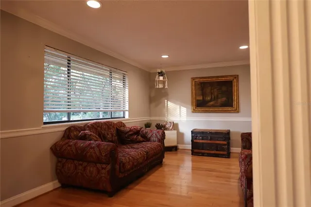 a view of a hallway with wooden floor and windows