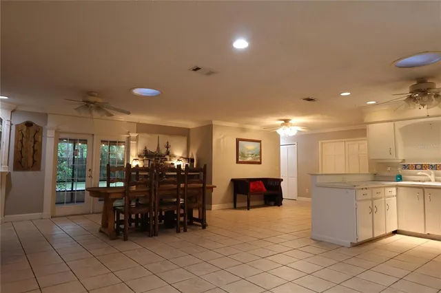a view of a big room with large windows and outdoor seating