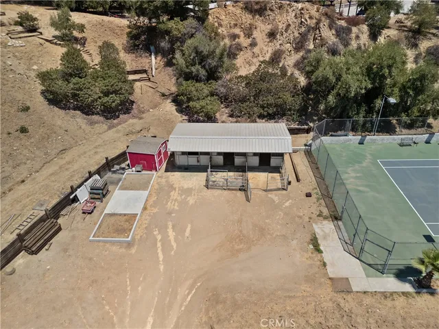a view of a dry yard with trees