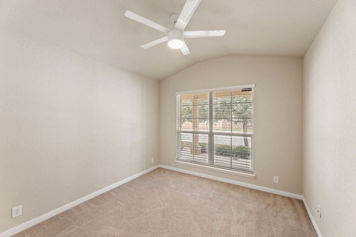 582 Briggs Drive New Braunfels, TX 78130 - Photo 24 of 32 an empty room with windows and ceiling fan