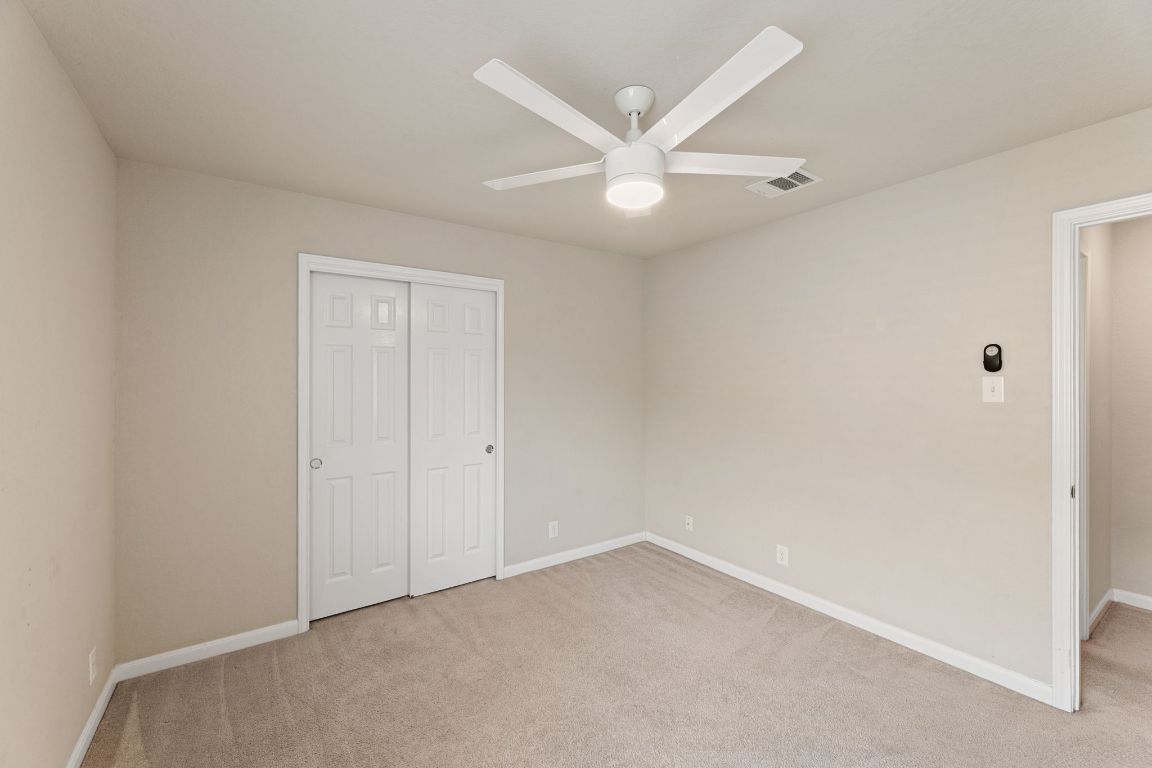 582 Briggs Drive New Braunfels, TX 78130 - Photo 29 of 32 an empty room with a ceiling fan and a window