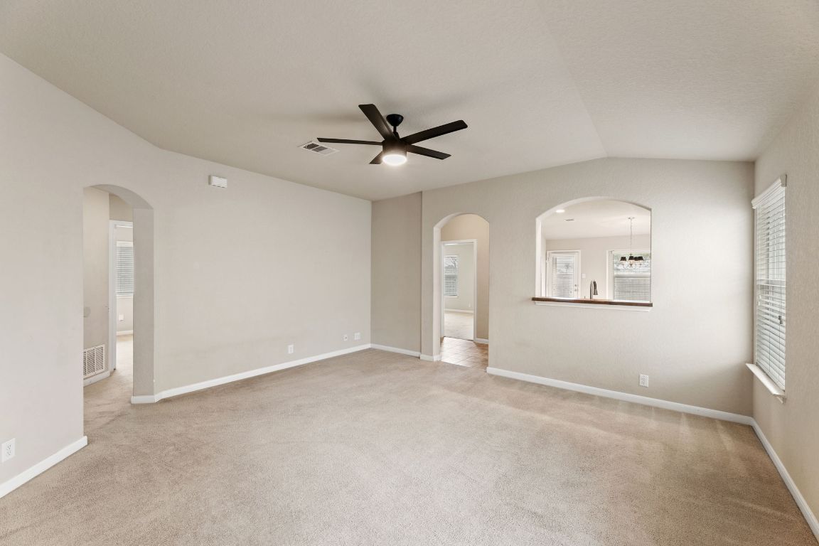 582 Briggs Drive New Braunfels, TX 78130 - Photo 5 of 32 an empty room with chandelier fan and windows