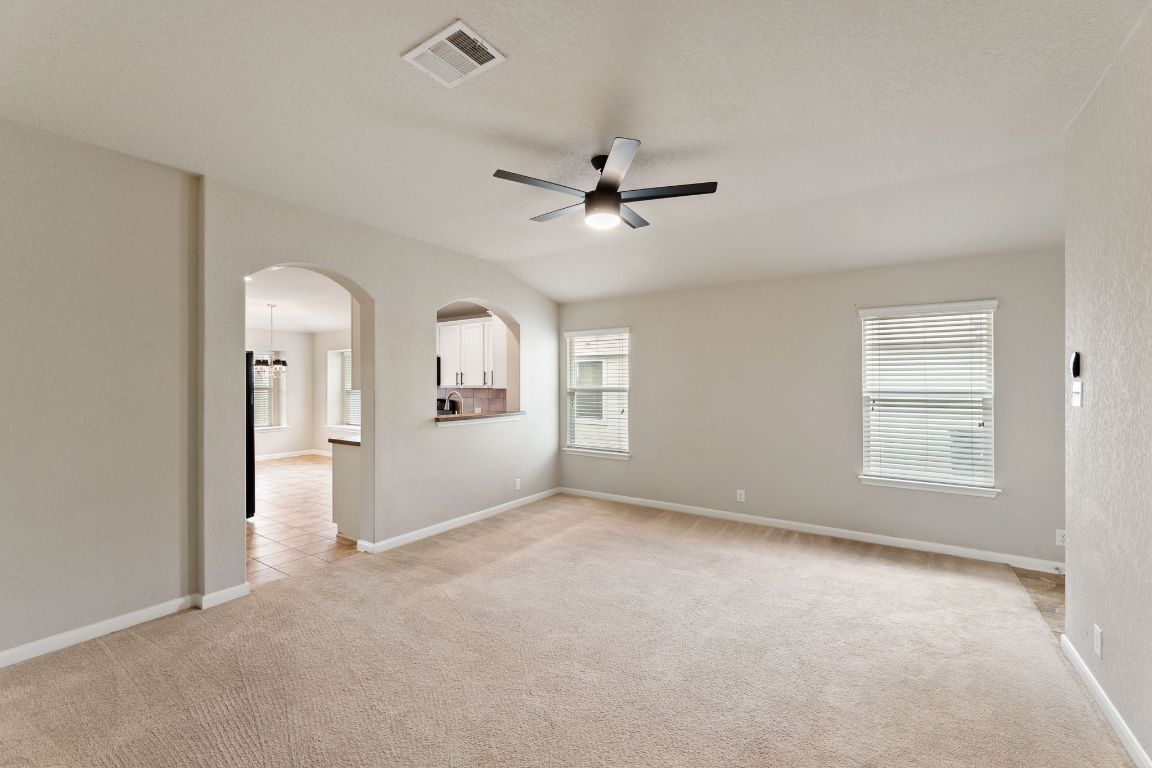 582 Briggs Drive New Braunfels, TX 78130 - Photo 8 of 32 a view of a livingroom with a ceiling fan and window