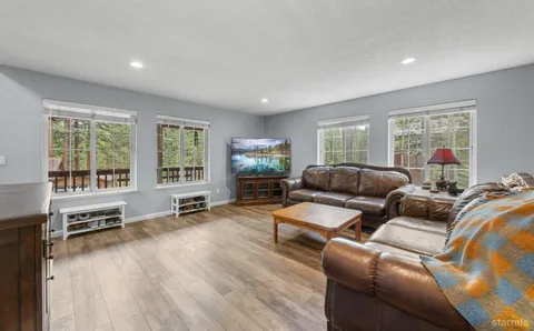 a living room with furniture window and wooden floor