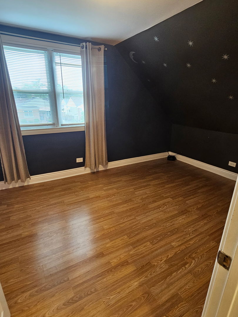 2436 Spruce Street River Grove, IL 60171 - Photo 14 of 19 an empty room with wooden floor and windows