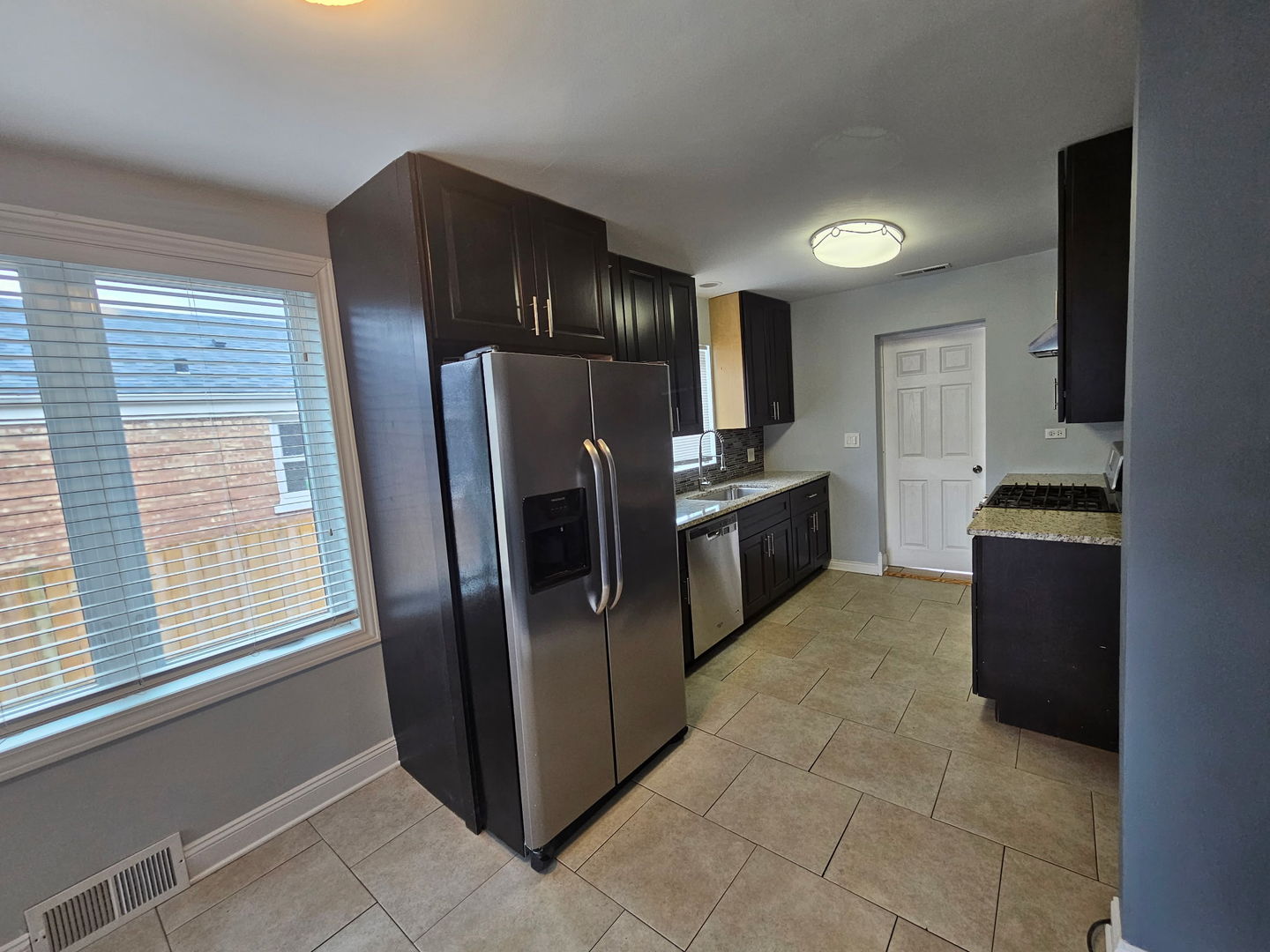 2436 Spruce Street River Grove, IL 60171 - Photo 5 of 19 a kitchen with stainless steel appliances granite countertop a refrigerator and a stove
