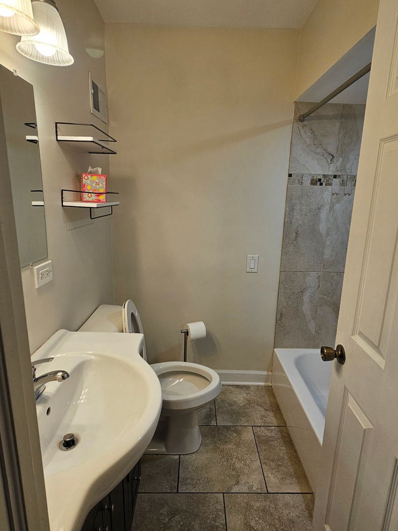 2436 Spruce Street River Grove, IL 60171 - Photo 7 of 19 a bathroom with a sink a toilet and shower