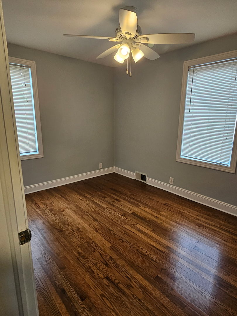 2436 Spruce Street River Grove, IL 60171 - Photo 8 of 19 an empty room with wooden floor fan and windows
