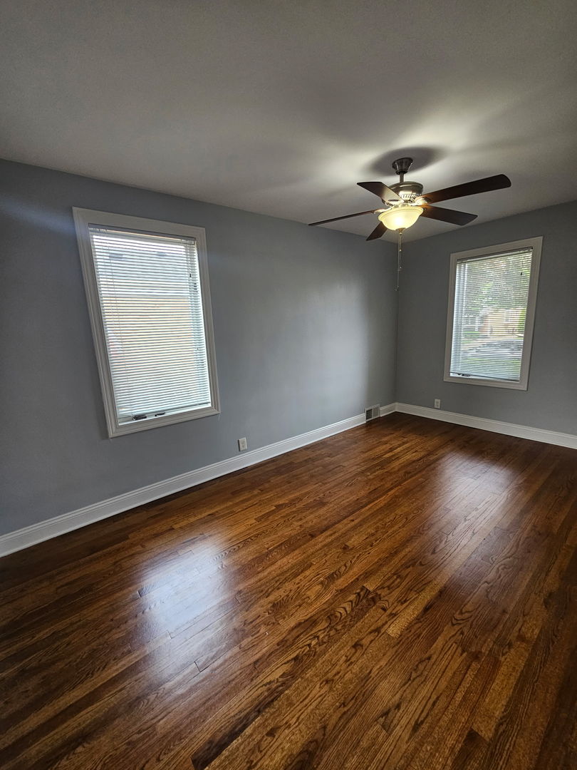 2436 Spruce Street River Grove, IL 60171 - Photo 10 of 19 a view of an empty room with a window and wooden floor