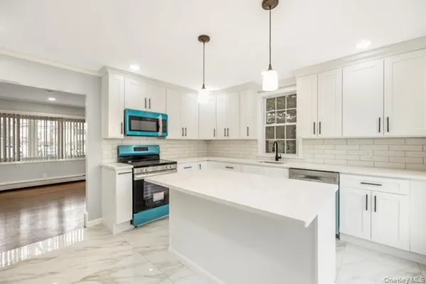 a kitchen with a sink a stove a microwave and cabinets