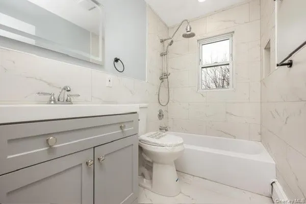 a bathroom with a sink toilet a bathtub and shower