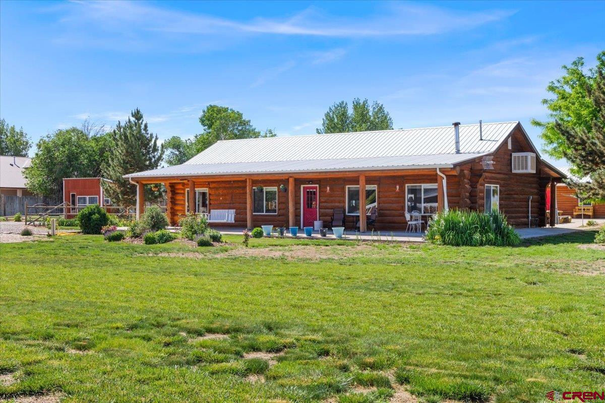 2083 Pioneer Road Delta, CO 81416 - Photo 3 of 45 a front view of a house with a yard table and chairs