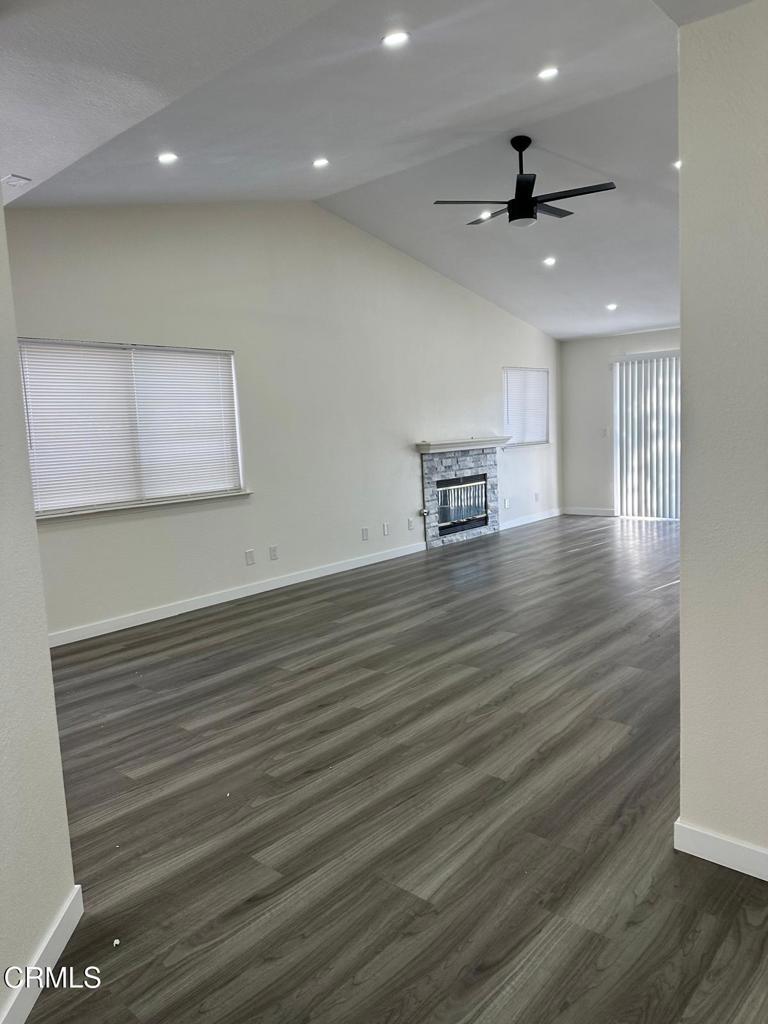 44839 16th Street East Lancaster, CA 93535 - Photo 12 of 53 a view of an empty room with wooden floor and a ceiling fan